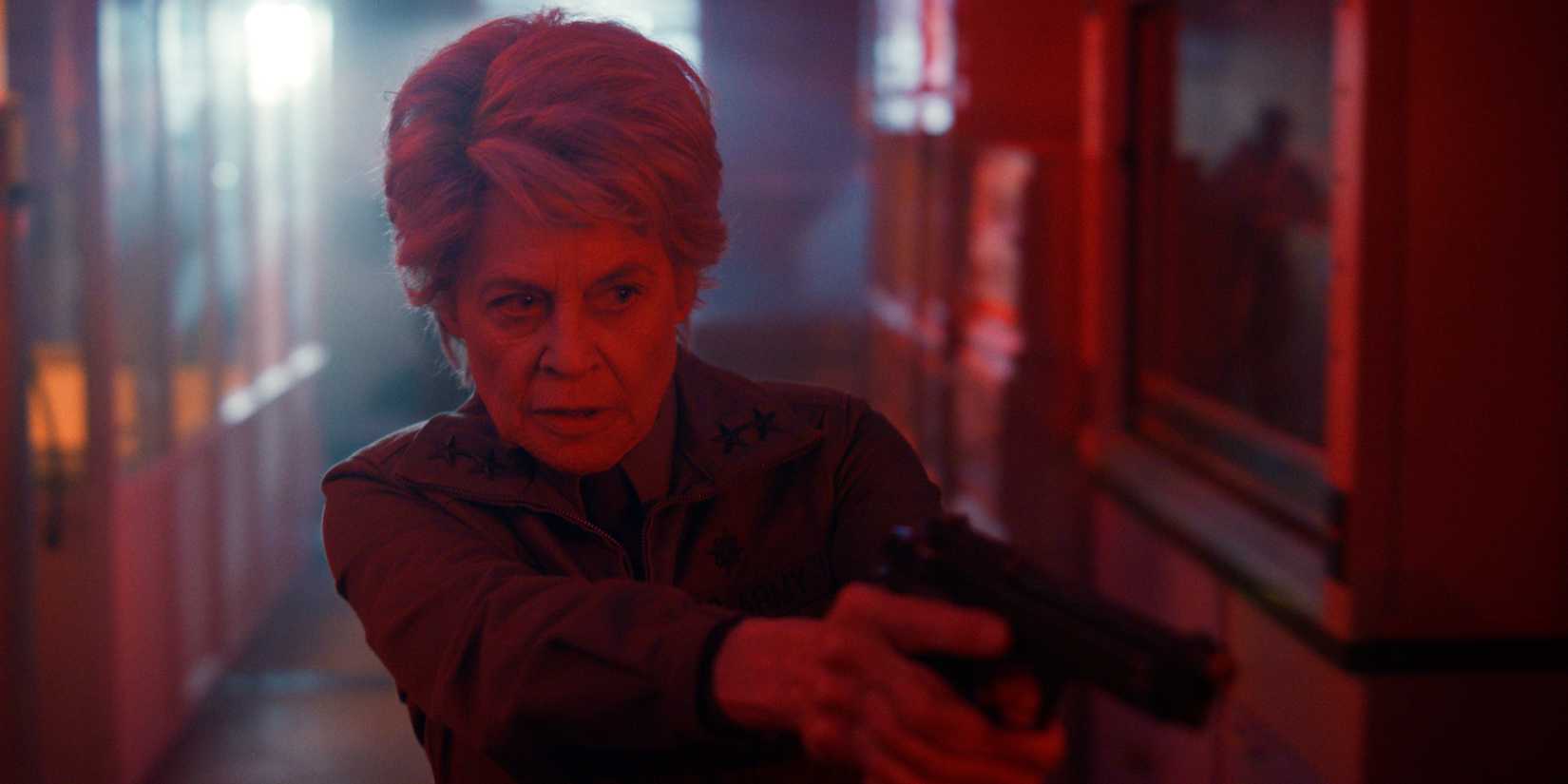 Linda Hamilton pointing a gun and looking around a corner in Stranger Things season 5