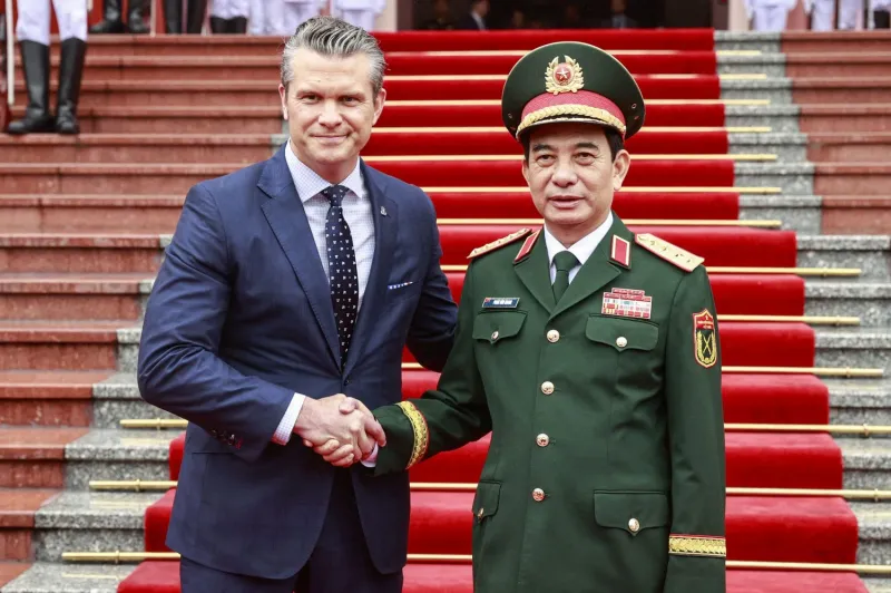 U.S. Defense Secretary Pete Hegseth and Vietnamese Defense Minister Phan Van Giang shake hands at the Defense Ministry’s headquarters in Hanoi, Vietnam, on Nov. 2.