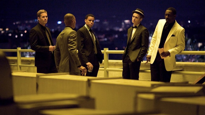 A group of men wearing flash suits in Takers