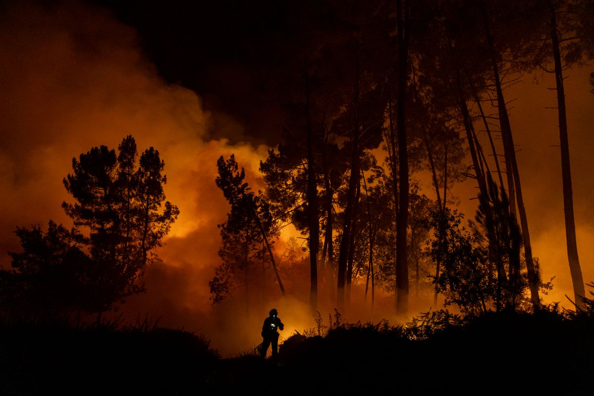 A member of the Emergency Military Unit (UME) works to extinguish a wildfire next to a village on August 19, 2025 in PepÃ­n, in Ourense province, Spain.