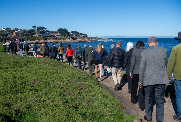People attending the memorial for Erica Fox, 55, the co-founder...