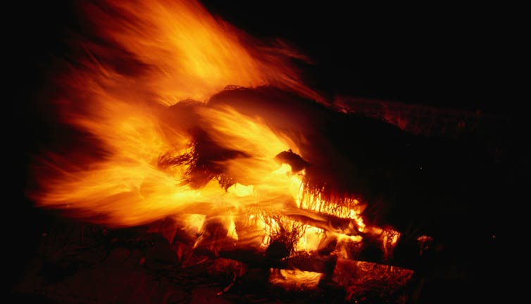 flames of a pyre against dark black background