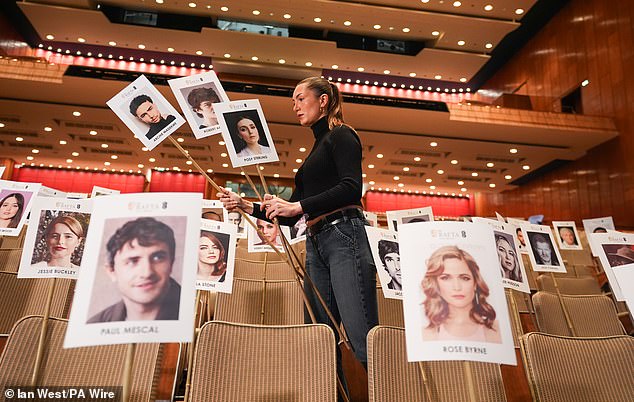 A staff member used 'heads on sticks' to check camera blocking at the Royal Festival Hall, London, ahead of the EE BAFTA Film Awards on Sunday