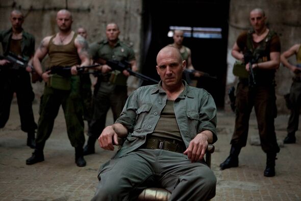ralph fiennes as coriolanus sitting in a chair ralph fiennes as coriolanus sitting in a chair