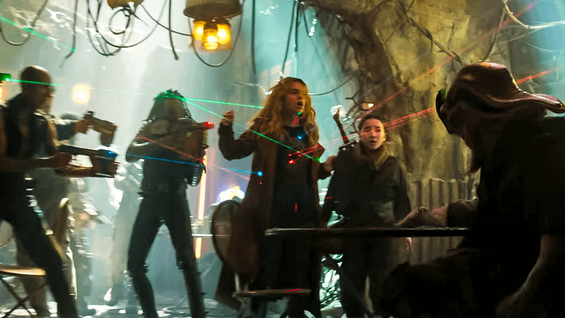 Milly Alcock as Supergirl with several laser sights pointed on her in Supergirl