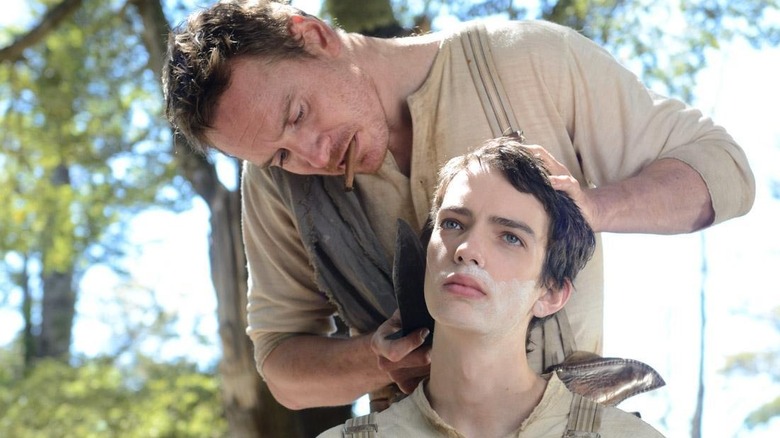 Michael Fassbender as Silas and Kodi Smit-McPhee as Jay, sharing a moment in Slow West