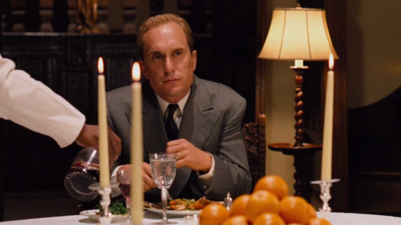 Tom Hagen sits at the dinner table in The Godfather