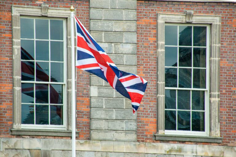 union-jack-flag-flutters-between-georgian-windows-on-historic-building.jpg