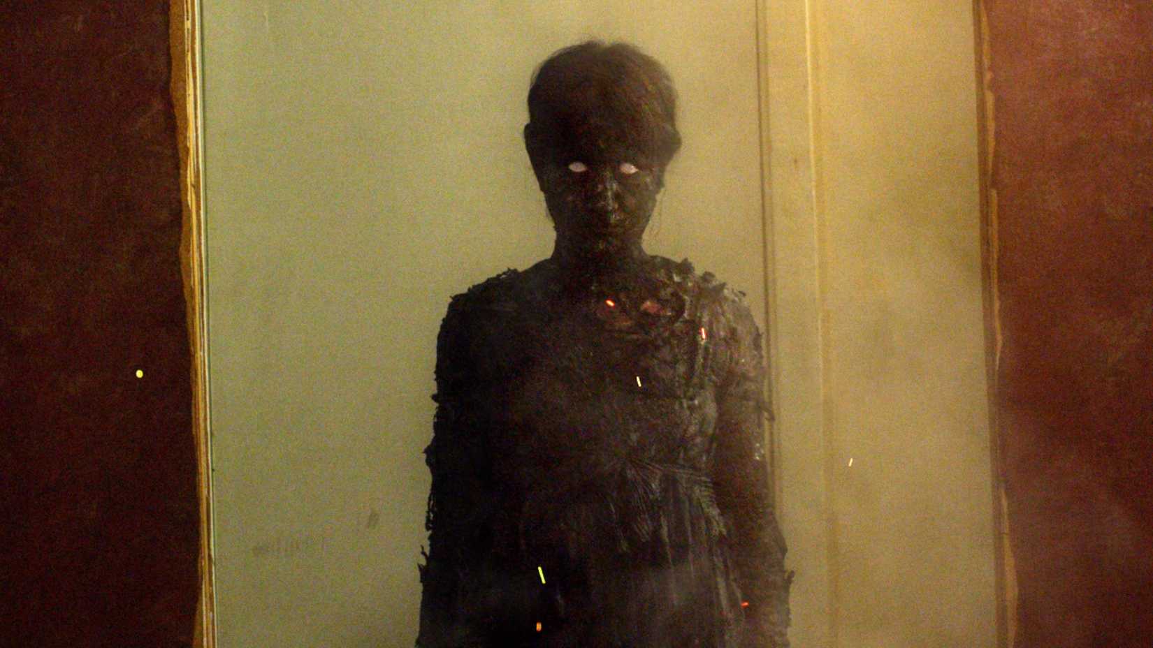 Burned up ghost in the horror film We Are Still Here (2015)