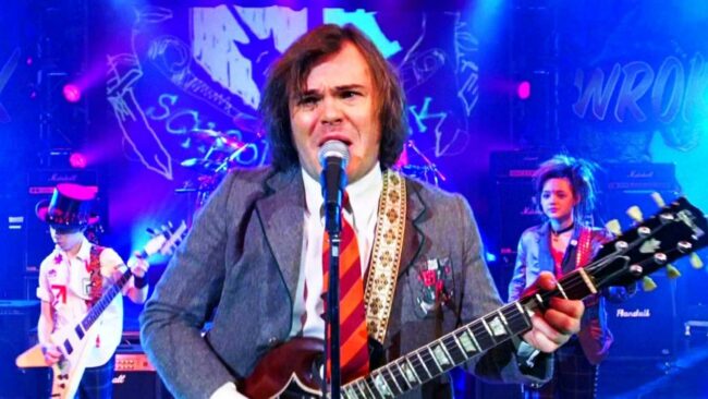 jack-black-as-dewie-finn-playing-guitar-on-stage-in-school-of-rock.jpg