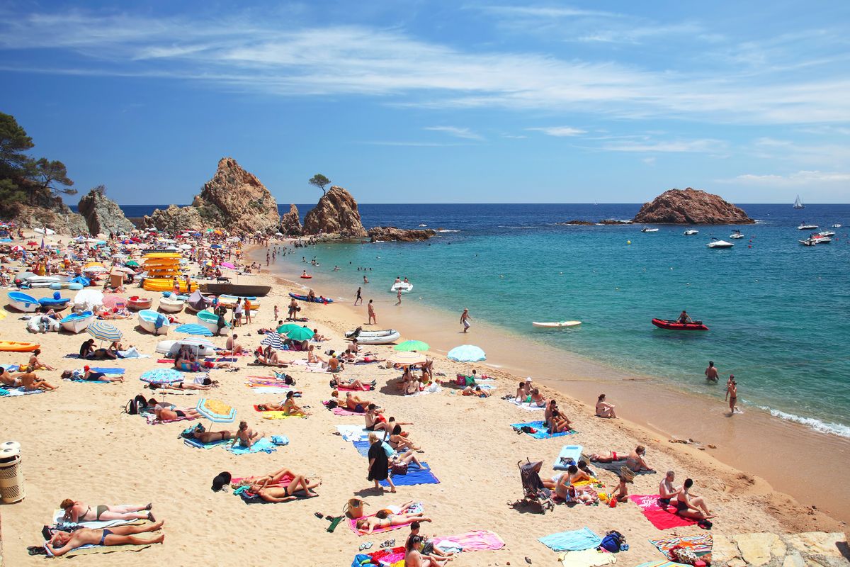 Tourists on the beach in Tossa de Mar