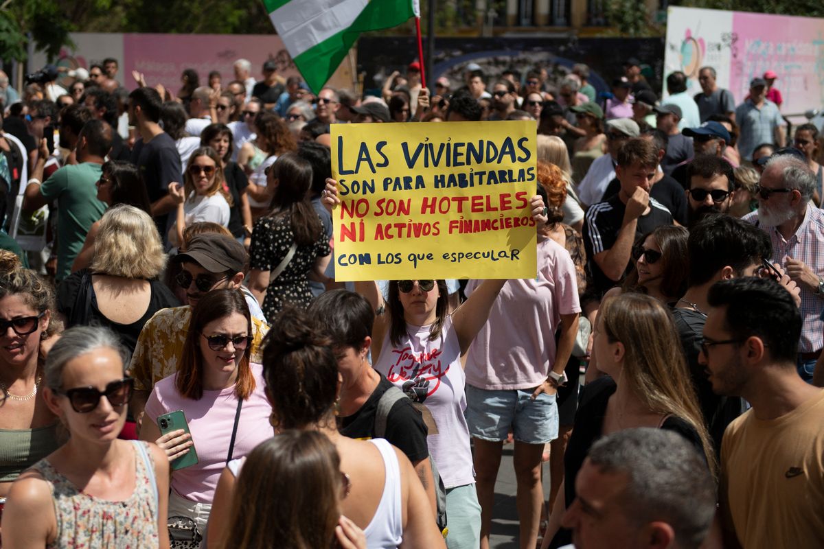 Protesters take part in a demonstration to protest against the massification of tourism and housing prices in Malaga on June 29, 2024. The banner reads 'Houses are made to live in, not hotels or financial assets to speculate with'