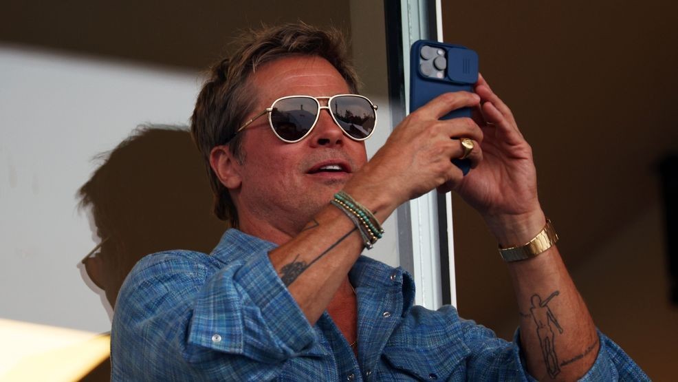 MEXICO CITY, MEXICO - OCTOBER 27: Brad Pitt takes a photo from the grandstand during the F1 Grand Prix of Mexico at Autodromo Hermanos Rodriguez on October 27, 2024 in Mexico City, Mexico. (Photo by Jared C. Tilton/Getty Images)
