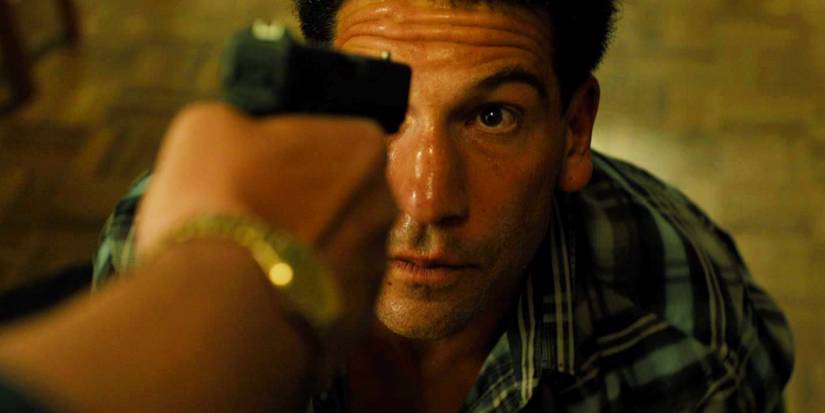 Jon Bernthal on the floor with a gun pointed at him in Sicario
