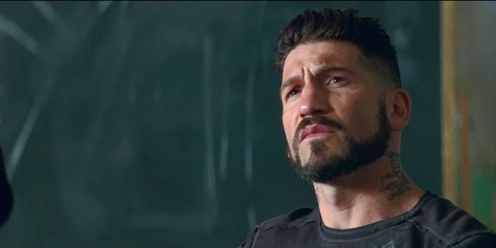 Griff (Jon Bernthal) sitting by a blackboard in Baby Driver