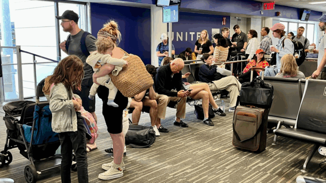 passengers-line-up-to-board-a-united-airlines-flight-during-the-busy-summer-travel-season-in-august-2025-in-boston.png