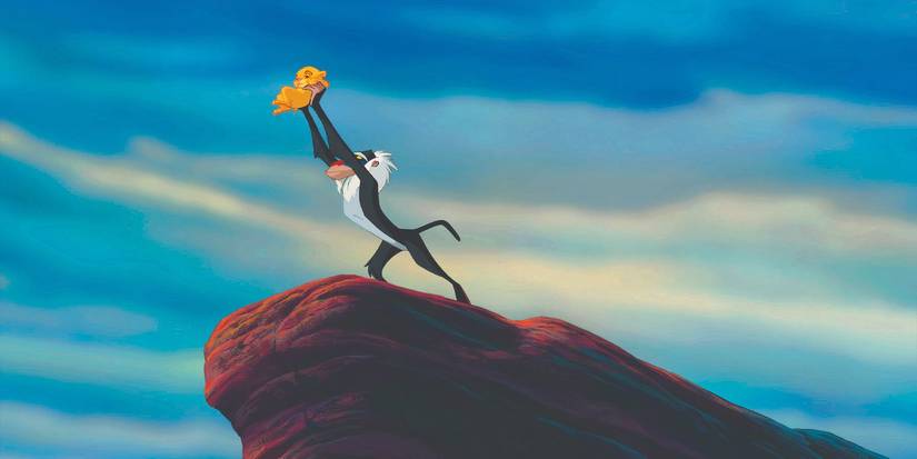 Rafiki holds a baby Simba in The Lion King