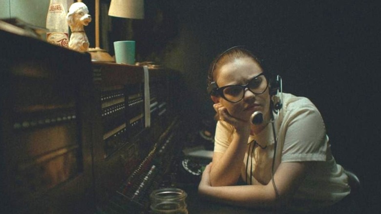 Sierra McCormick as Fay Crocker sitting at the switchboard looking perplexed in The Vast of Night