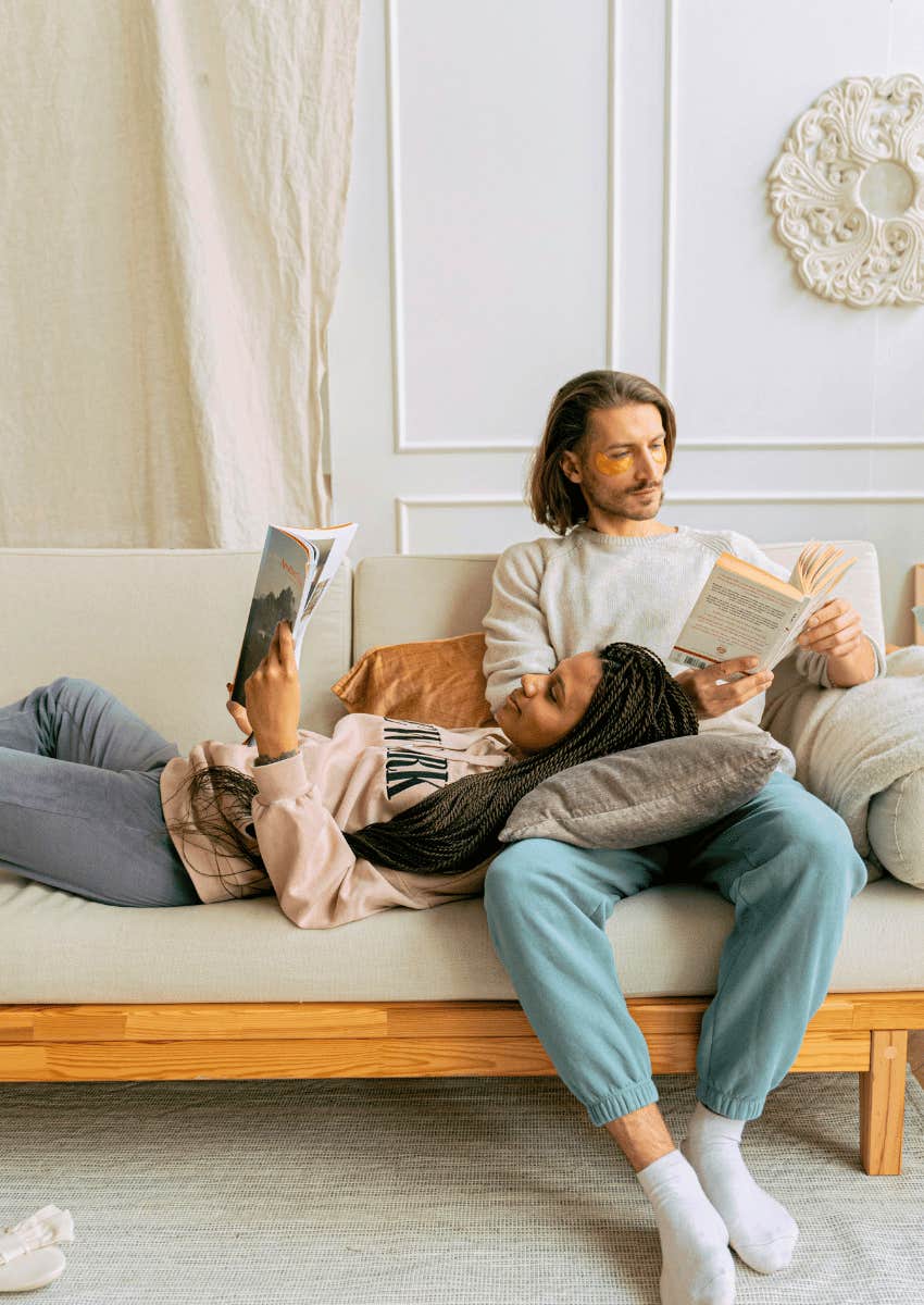 two people reading on couch together