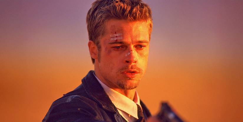 A close-up of Detective Mills (Brad Pitt) crying while holding a gun in Se7en.