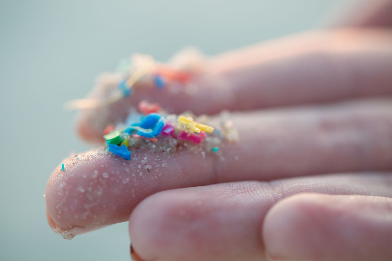 A photograph of microplastics in the hand.