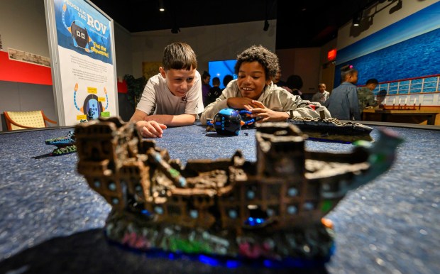 Allentown School District fifth graders Jocsan and Xavier play with miniature remotely operated vehicles in the 