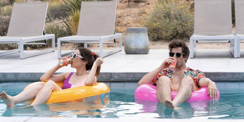 Nyles and Sarah drinking while floating on a pool in 'Palm Springs'