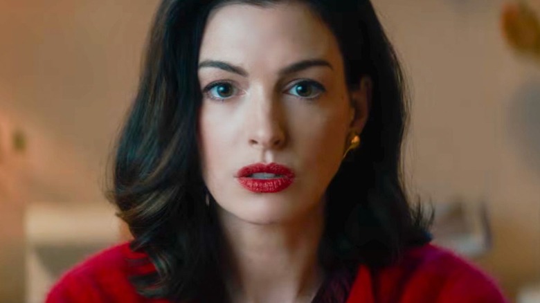 Verity in close-up wearing red with red lipstick in Verity