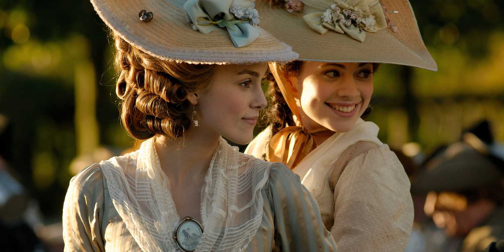 Georgiana de Cavendish and Bess Foster looking in the same direction and smiling in The Duchess (2008)