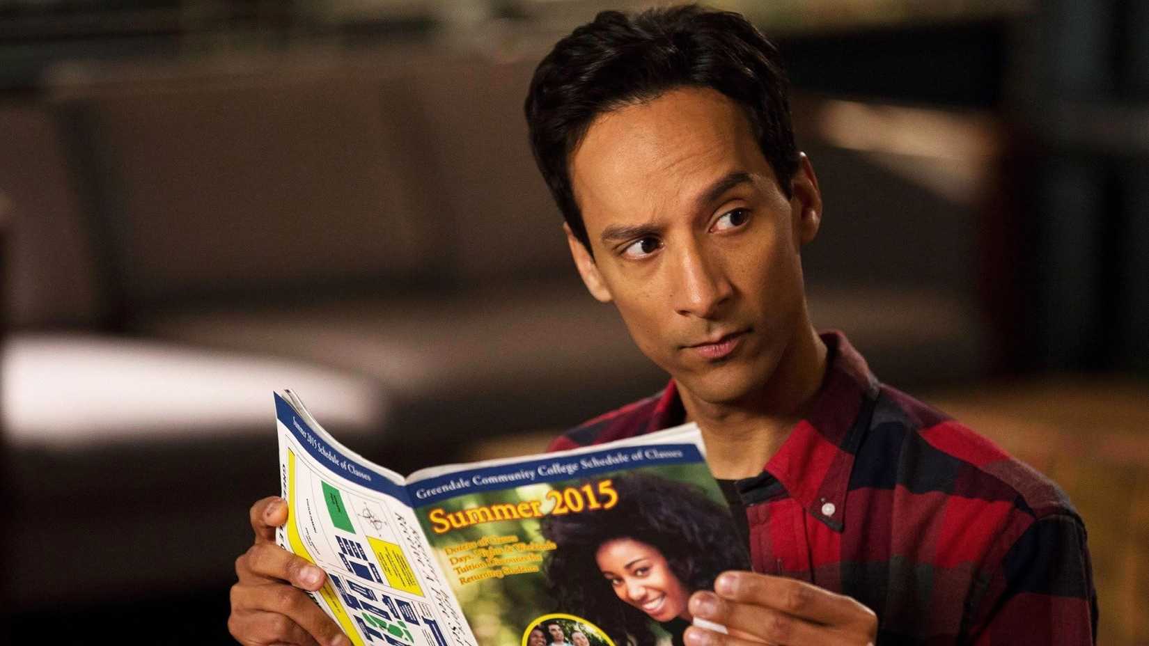 Danny Pudi as Abed Nadir reading a magazine in Community