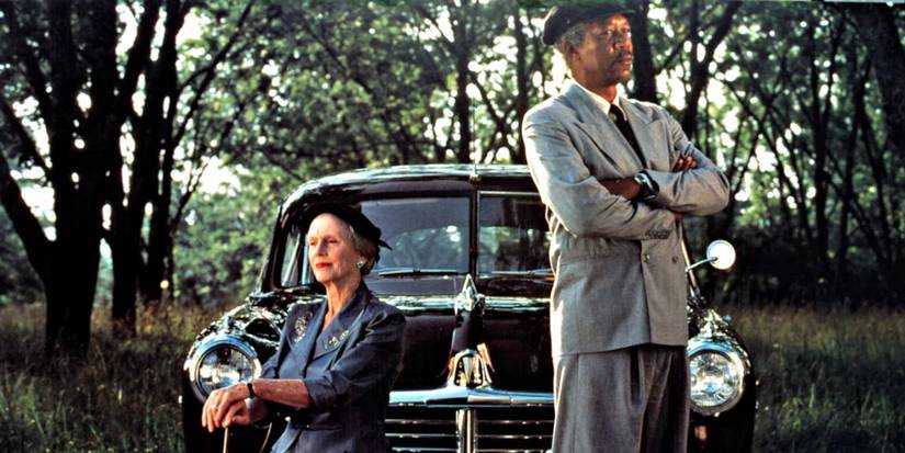 Morgan Freeman and Jessica Tandy as Daisy and Hoke in front of car in 'Driving Miss Daisy'.