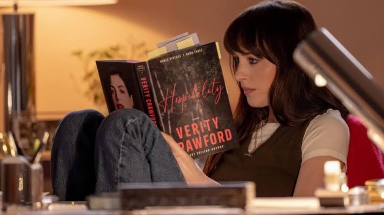 Lowen reading one of Verity Crawford's thrillers in Verity
