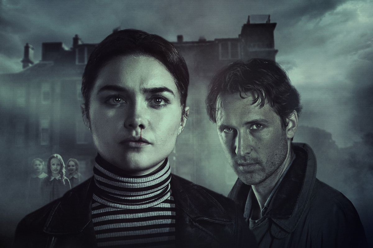 A serious woman and man stand in the foreground with an ominous, foggy building and small group of people in the background, creating a mysterious and suspenseful atmosphere.